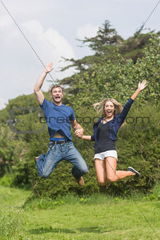 Cute couple jumping and smiling