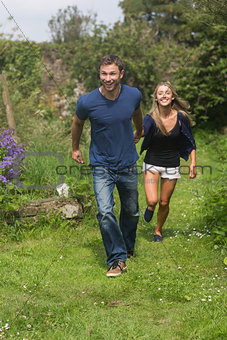 Cute couple running holding hands