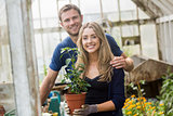 Cute couple gardening in greenhouse