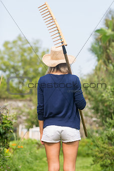 Gardening blonde holding a rake