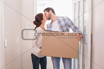 Cute couple carrying cardboard box