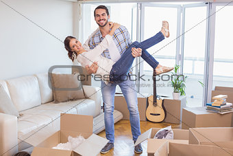 Cute couple unpacking cardboard boxes