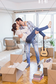 Cute couple unpacking cardboard boxes