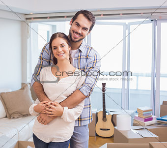 Cute couple hugging and smiling at camera
