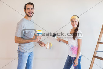 Cute couple painting the wall