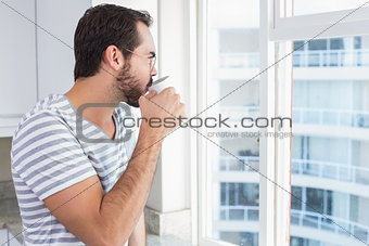 Young man looking out his window