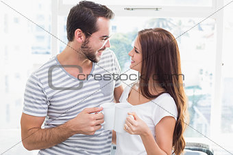 Young couple toasting their coffees