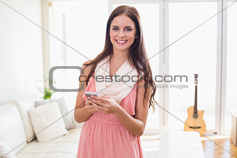 Hipster brunette using her smartphone