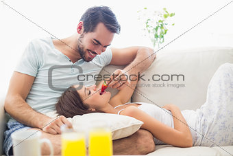 Cute couple relaxing on couch at breakfast