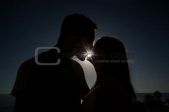 Cute couple kissing in silhouette
