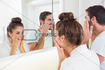 Young couple putting on face cream