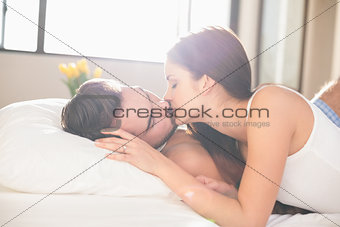 Young couple kissing in bed