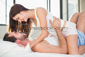 Young couple having fun in bed