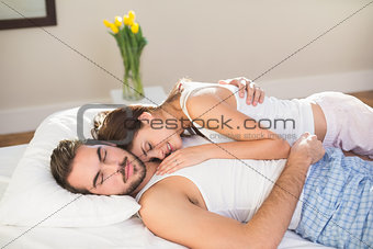 Young couple cuddling in bed