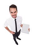 Smiling businessman standing and holding laptop