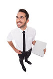 Happy businessman holding laptop and looking up