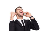 Cheering businessman in suit on the phone
