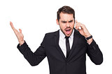Angry businessman gesturing on the phone