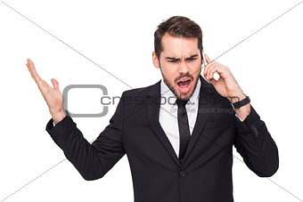 Angry businessman gesturing on the phone
