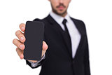 Businessman showing smartphone to camera