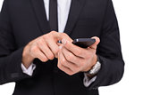 Mid section of a businessman using smartphone