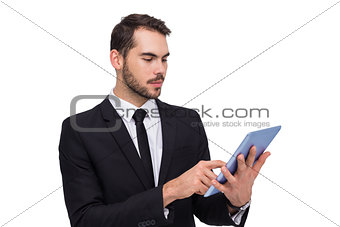 Cheerful businessman touching digital tablet