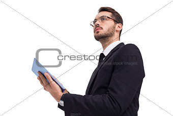 Businessman looking away while using tablet