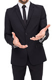 Mid section of a businessman showing with his hands