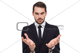 Cheerful businessman presenting with his hands