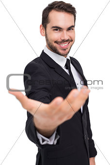 Smiling businessman with his hand out