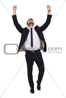 Cheerful businessman with arms up cheering