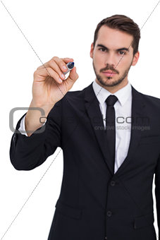 Serious businessman writing with marker