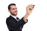Smiling businessman writing with black marker