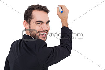 Happy businessman writing with marker