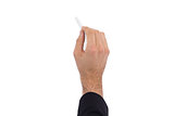 Hand of a businessman writing with a white chalk