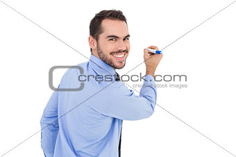 Happy businessman in shirt writing with marker