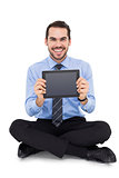 Smiling businessman showing his digital tablet