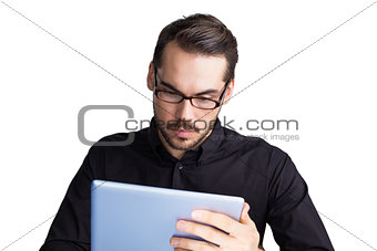 Cheerful businessman in glasses using tablet