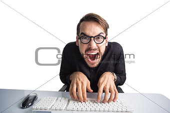 Excited businessman typing on keyboard