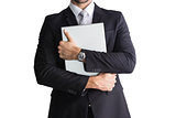Mid section of businessman holding computer