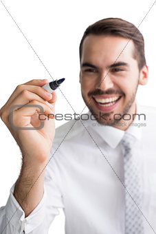 Happy businessman standing and writing with marker