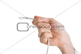 Hand of businessman holding white cable
