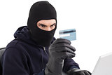 Burglar using credit card and laptop