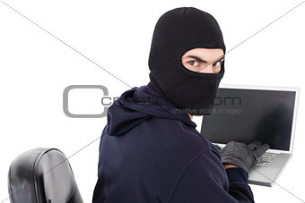 Hacker sitting and hacking laptop