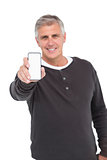 Casual man showing his smartphone