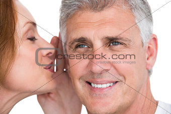 Woman telling secret to her partner