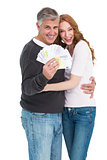 Casual couple showing their cash
