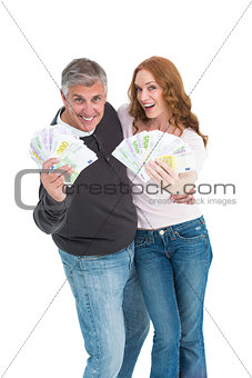 Casual couple showing their cash