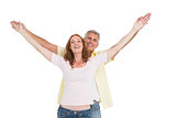 Casual couple smiling with arms raised