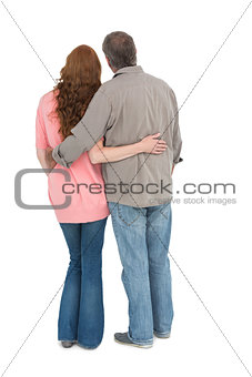 Casual couple standing arms around